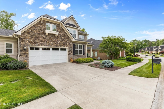 462 Chapel Grove Ln, Knoxville, TN 37934 - view of front facade with stone siding, concrete driveway, a front yard, and an attached garage