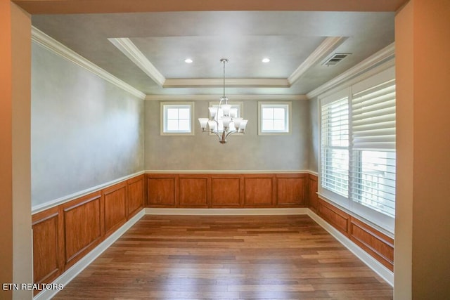 462 Chapel Grove Ln, Knoxville, TN 37934 - unfurnished dining area with wood-type flooring, a raised ceiling, a chandelier, wainscoting, and crown molding