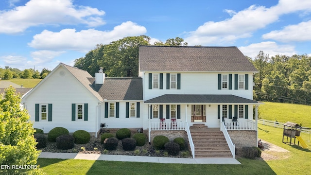 1182 Murrell Rd, Morristown, TN 37814 - view of front of property featuring covered porch, stairway, a front lawn, a chimney, and roof with shingles