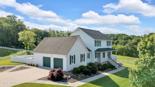 1182 Murrell Rd, Morristown, TN 37814 - view of front of house featuring covered porch, concrete driveway, a shingled roof, and an attached garage