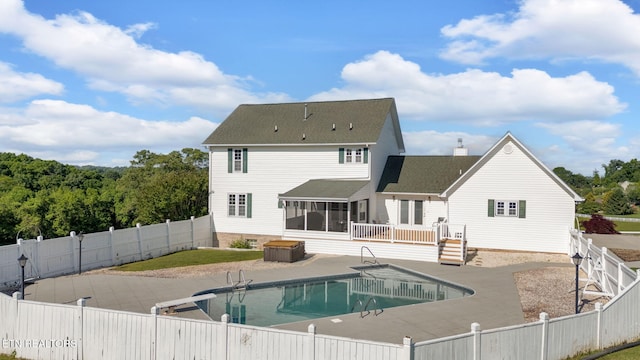 1182 Murrell Rd, Morristown, TN 37814 - rear view of house featuring a fenced backyard, a sunroom, a chimney, a patio area, and a shingled roof