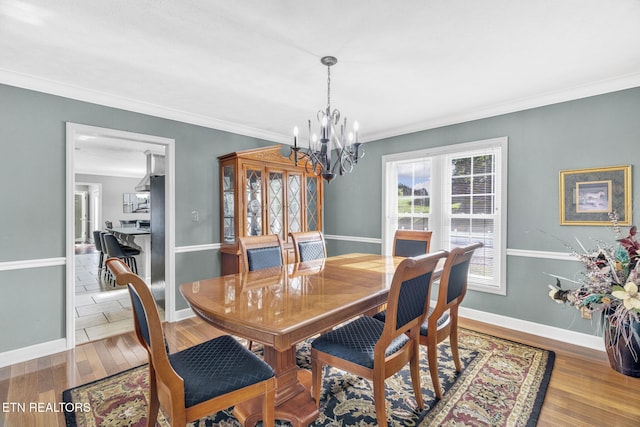 1182 Murrell Rd, Morristown, TN 37814 - dining room with a chandelier, wood finished floors, ornamental molding, and baseboards