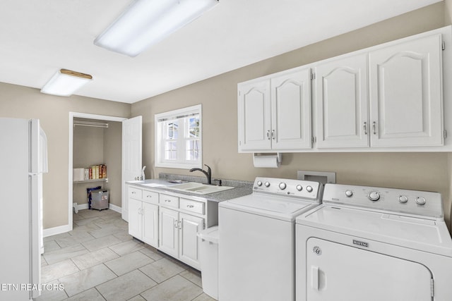 1182 Murrell Rd, Morristown, TN 37814 - clothes washing area with cabinet space, washing machine and clothes dryer, baseboards, and light tile patterned flooring