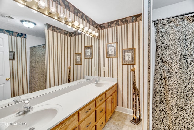 1182 Murrell Rd, Morristown, TN 37814 - bathroom featuring tile patterned flooring, double vanity, wallpapered walls, and baseboards