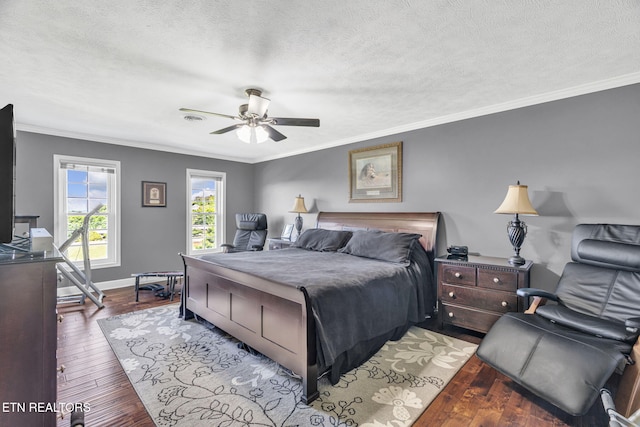 1182 Murrell Rd, Morristown, TN 37814 - bedroom with crown molding, wood-type flooring, a textured ceiling, ceiling fan, and baseboards