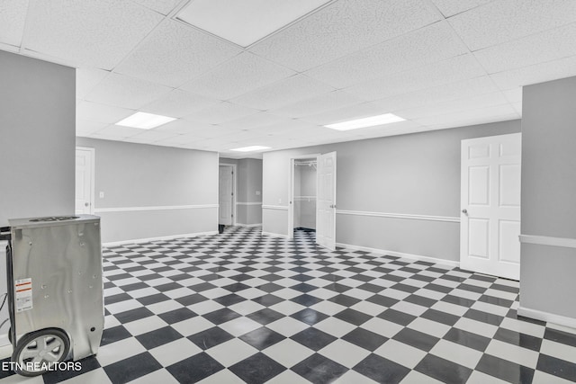 1182 Murrell Rd, Morristown, TN 37814 - basement with tile patterned floors, a paneled ceiling, and baseboards
