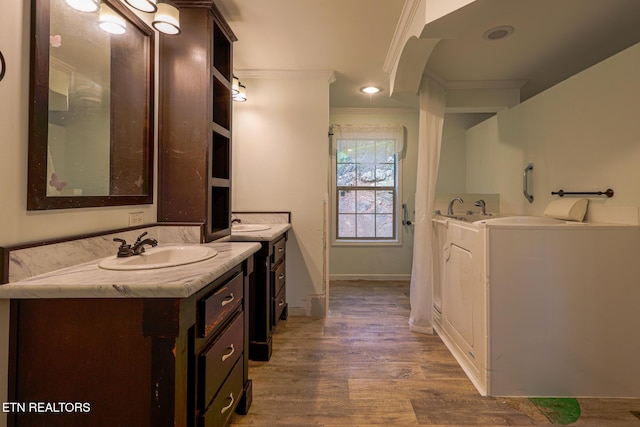 915 Yellow Breeches Rd, Cosby, TN 37722 - bathroom with two vanities, crown molding, wood finished floors, a garden tub, and baseboards