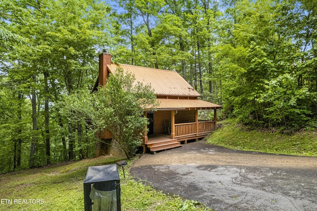 rustic home with a chimney and metal roof