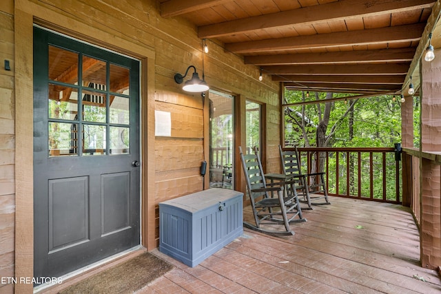 wooden terrace featuring covered porch