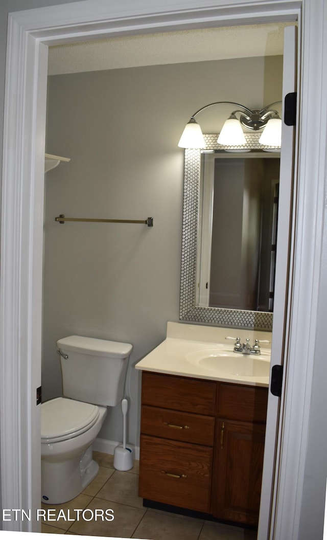 33 Wood Ln, Sparta, TN 38583 - bathroom featuring tile patterned floors, vanity, toilet, and baseboards