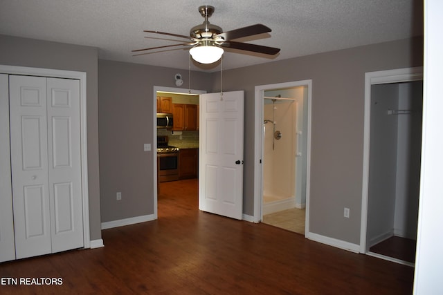 33 Wood Ln, Sparta, TN 38583 - unfurnished bedroom with wood finished floors, baseboards, connected bathroom, and a textured ceiling