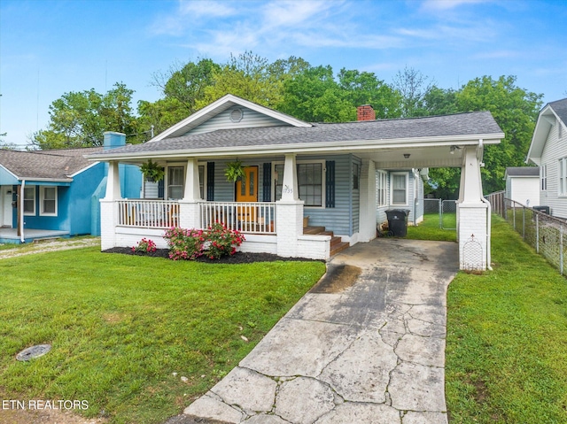 1735 NE Albert Ave, Knoxville, TN 37917 - view of front of house with concrete driveway, a chimney, covered porch, an attached carport, and a shingled roof