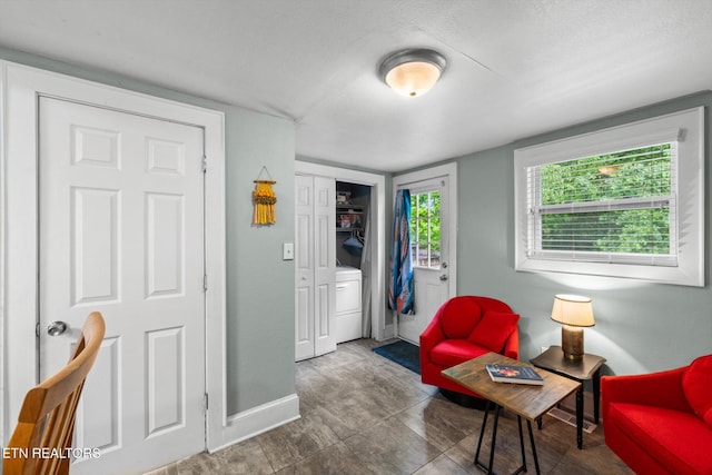 1735 NE Albert Ave, Knoxville, TN 37917 - living area with baseboards, washer / clothes dryer, and a textured ceiling