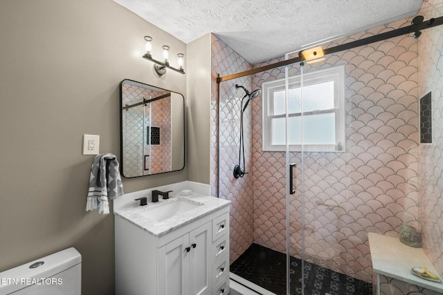 1735 NE Albert Ave, Knoxville, TN 37917 - bathroom with a textured ceiling, vanity, toilet, and a stall shower
