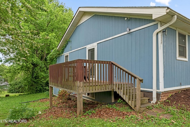 rear view of property featuring a wooden deck