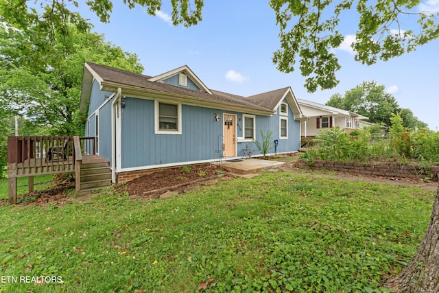 ranch-style house with a deck and a front yard