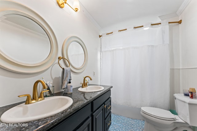 bathroom featuring toilet, crown molding, and double vanity