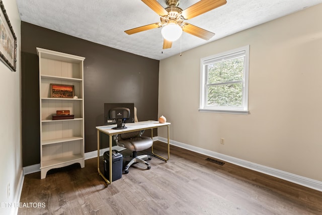 office area with wood finished floors, baseboards, a textured ceiling, and a ceiling fan