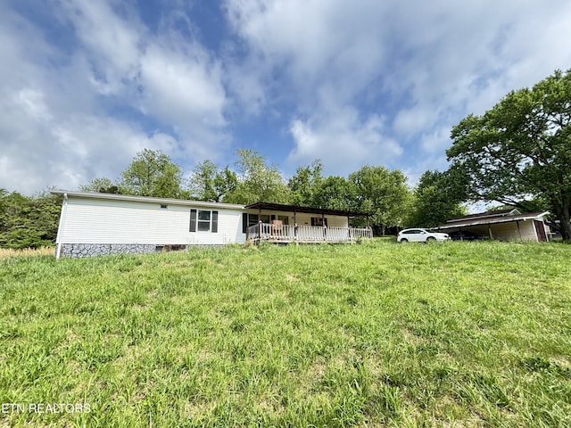 back of house with a lawn