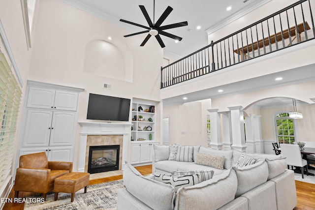 12618 Hunters Creek Ln, Knoxville, TN 37922 - living area with light wood-style floors, arched walkways, ceiling fan, ornate columns, and crown molding