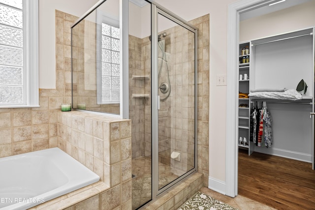 12618 Hunters Creek Ln, Knoxville, TN 37922 - full bathroom featuring a stall shower, a spacious closet, a garden tub, baseboards, and tile patterned floors