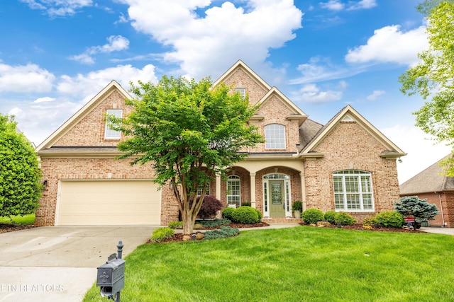 12618 Hunters Creek Ln, Knoxville, TN 37922 - traditional-style home featuring brick siding, a front yard, a garage, and concrete driveway