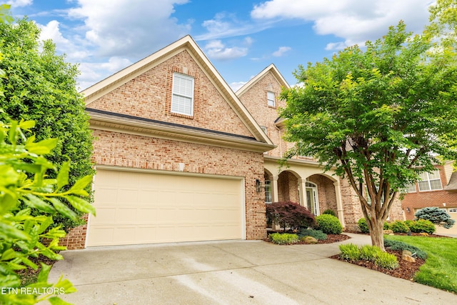 12618 Hunters Creek Ln, Knoxville, TN 37922 - traditional home with concrete driveway, brick siding, and a garage