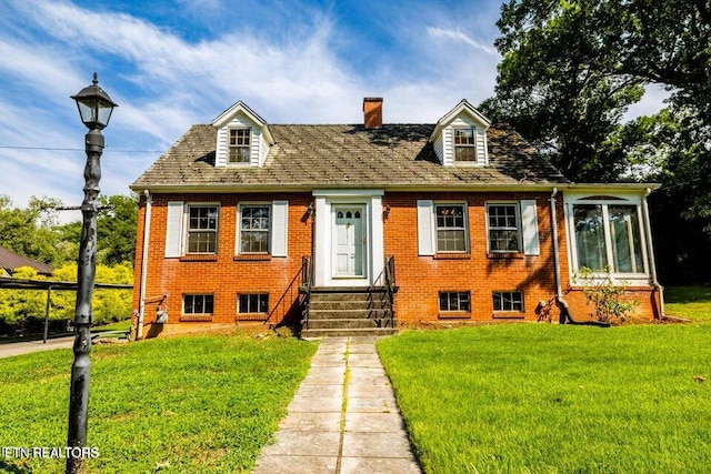 1210 Chilhowee Ave, Maryville, TN 37801 - cape cod house with entry steps, a front lawn, a chimney, and brick siding