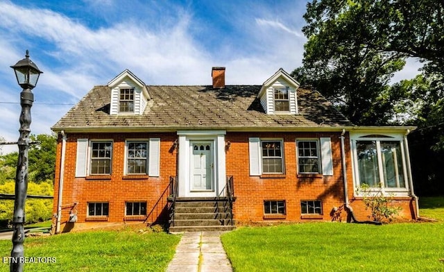 1210 Chilhowee Ave, Maryville, TN 37801 - new england style home featuring entry steps, a front yard, brick siding, and a chimney