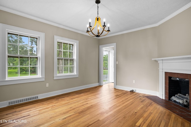 1210 Chilhowee Ave, Maryville, TN 37801 - unfurnished living room featuring light wood finished floors, a chandelier, crown molding, a tiled fireplace, and baseboards