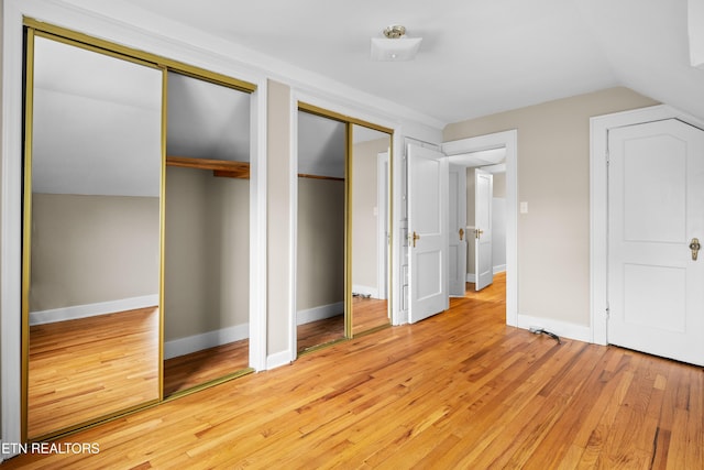 1210 Chilhowee Ave, Maryville, TN 37801 - unfurnished bedroom with multiple closets, light wood-style floors, vaulted ceiling, and baseboards