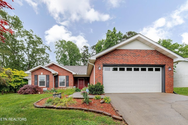 702 Shane Dr, Maryville, TN 37804 - view of front of home with brick siding, asphalt driveway, a front yard, and an attached garage