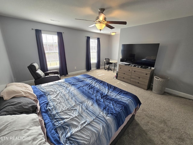 bedroom with carpet flooring, baseboards, and a ceiling fan