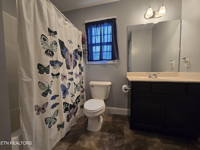 bathroom with toilet, baseboards, vanity, stone finish floors, and shower / bath combination with curtain