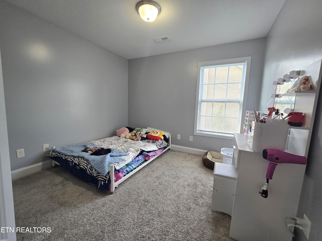 bedroom with carpet flooring and baseboards