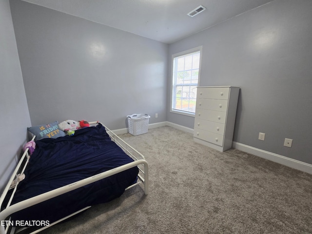 bedroom with carpet flooring and baseboards