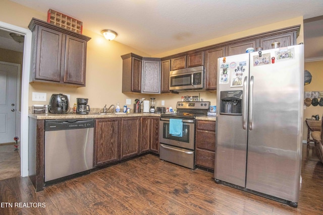 146 Prospect Rd, Maynardville, TN 37807 - kitchen featuring appliances with stainless steel finishes, dark wood-type flooring, light countertops, and dark brown cabinetry