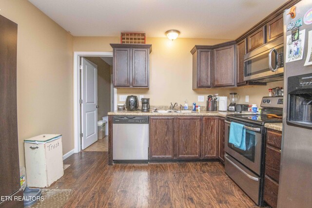 146 Prospect Rd, Maynardville, TN 37807 - kitchen featuring appliances with stainless steel finishes, a sink, dark wood-style flooring, light countertops, and dark brown cabinets