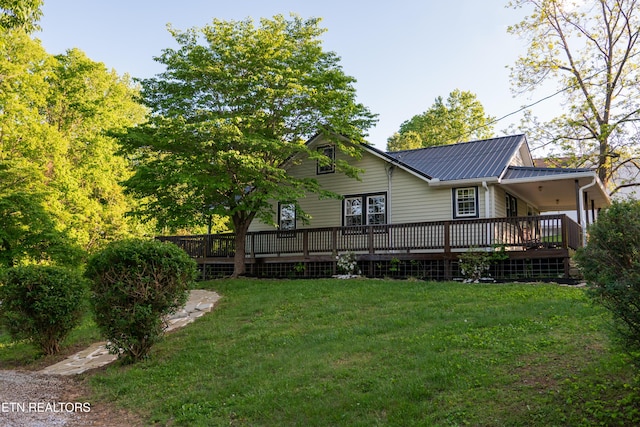 204 E Howard Rd, Livingston, TN 38570 - back of property with a wooden deck, a lawn, and metal roof