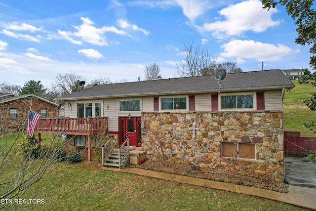 view of front facade with stone siding, a wooden deck, and a front lawn