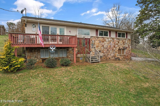 rear view of property featuring stone siding, a deck, and a lawn