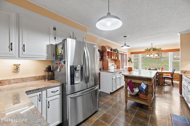 kitchen featuring stainless steel refrigerator with ice dispenser, a textured ceiling, white cabinets, decorative light fixtures, and open shelves