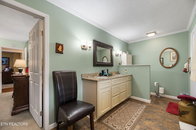 bathroom featuring a textured ceiling, ornamental molding, baseboards, and vanity