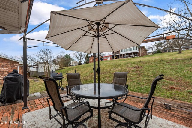 view of patio / terrace featuring outdoor dining space and a deck