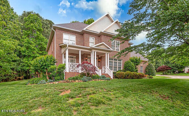 515 Oak Landing Ln Unit 4, Knoxville, TN 37934 - traditional-style house with brick siding, a porch, and a front lawn