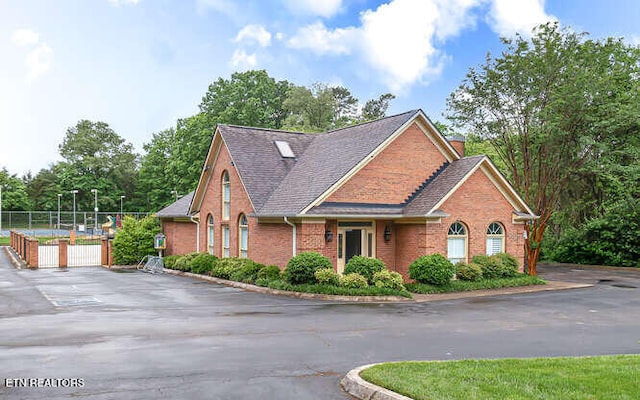 515 Oak Landing Ln Unit 4, Knoxville, TN 37934 - view of front of property featuring brick siding, fence, a chimney, and a shingled roof