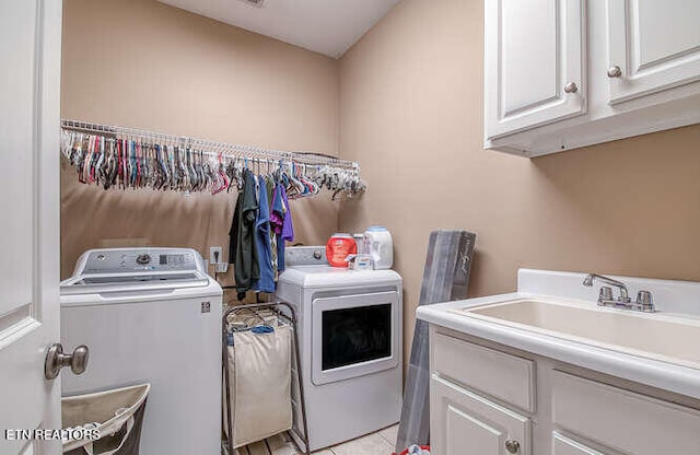515 Oak Landing Ln Unit 4, Knoxville, TN 37934 - laundry room featuring washing machine and clothes dryer, cabinet space, and light tile patterned flooring