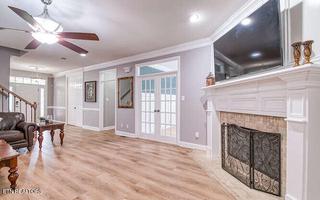 515 Oak Landing Ln Unit 4, Knoxville, TN 37934 - living area featuring ornamental molding, ceiling fan, a tile fireplace, light wood finished floors, and french doors