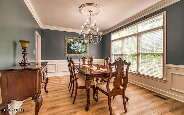 515 Oak Landing Ln Unit 4, Knoxville, TN 37934 - dining space featuring ornamental molding, a chandelier, wainscoting, light wood finished floors, and a decorative wall