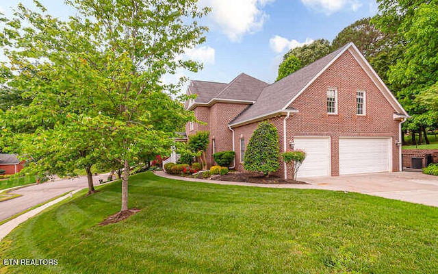 515 Oak Landing Ln Unit 4, Knoxville, TN 37934 - traditional-style house featuring driveway, an attached garage, brick siding, and a front yard